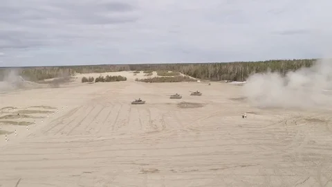 Three T90 tanks travel through the sand and shoot Stock Footage 76838381