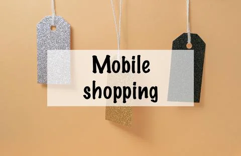 Three tags hanging from a string that say mobile shopping Stock Photos