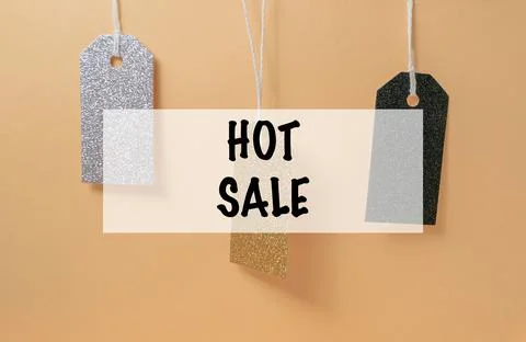 Three tags hanging from a string with the words HOT SALE written below them Stock Photos