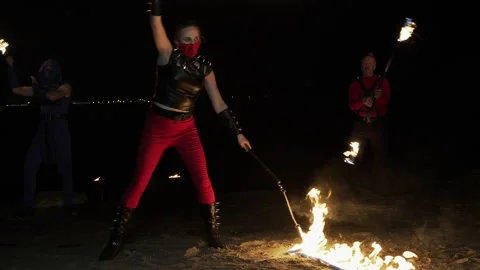 Three talented fire performers of different genders doing a show Stock Footage 145587374