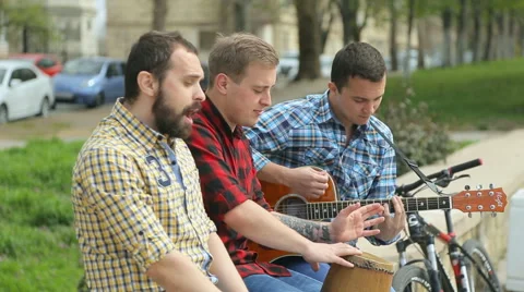 Three talented guys perform on the street with passion Stock Footage 50681091