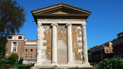 Three tall fluted ionic columns stand patchwork stone façade triangular pediment Stock Footage 324872170