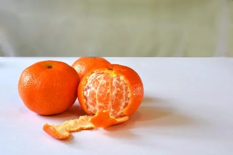 Three tangerine on a white table. Stock Photos