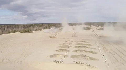 	Three tanks travel through the sand and shoot Stock Footage 76846566