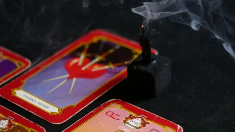Three tarot swords and an extinguished black candle Stock Footage 235003382