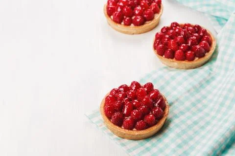 Three tartlets with raspberries. Stock Photos