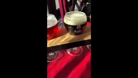 Three tasting glasses of Leffe beer blonde brown and ruby, close up Vídeos de archivo 330672865