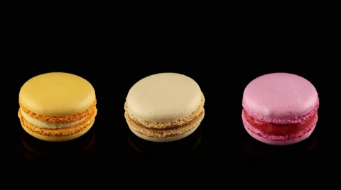Three tasty colorful macarons rotating Stock Footage 58664143