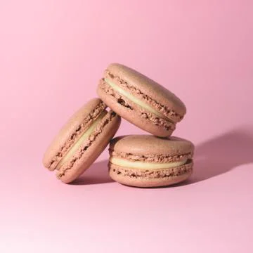 Three tasty macarons on the bright background. Stock Photos