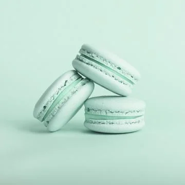 Three tasty macarons on the bright background. Stock Photos