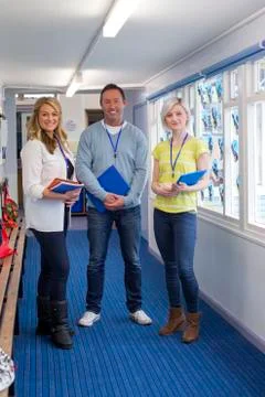 Three Teachers in School Corridor Stock Photos