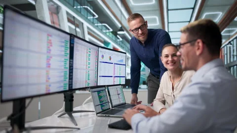 Three Team Members Study Spreadsheets And Data Reports Together Stock Footage 337224077