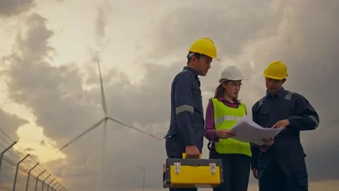 Three technician engineer in uniform with standing and checking wind turbine. Stock Footage 233245102