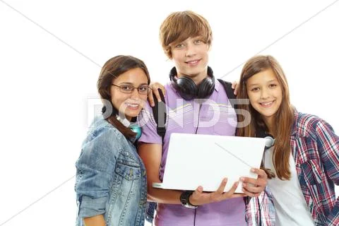 Three teenagers with laptop looking at camera Stock Photos