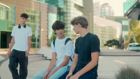 Three teens shaking hands and greeting each other happily in the city Video stock 320156590