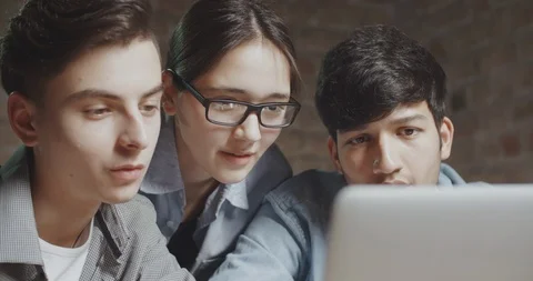 Three teens working on project or presentation together. students preparing for Stock Footage 92997853