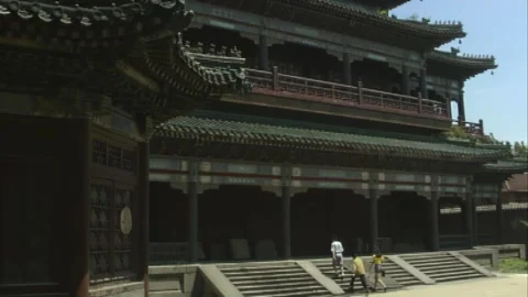 The three of them approached the ancient building Stock Footage 253772447