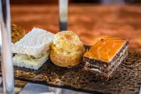 Three tier afternoon tea set and pastries Stock Photos