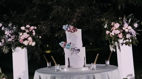 Three-tier wedding cake in the evening Stock Footage 253542294