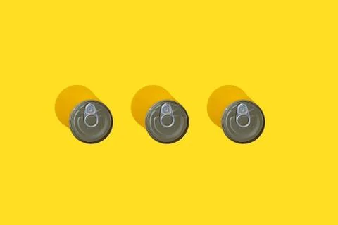 Three tin can top view on yellow background with hard shadow. The concept stocks Stock Photos