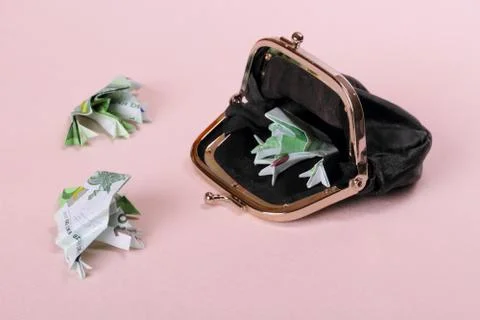 Three toads of one hundred and purse Stock Photos
