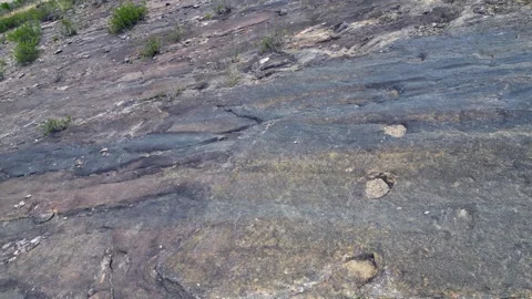 Three toed bipedal dinosaur footprints fossilized at Toro Toro Bolivia Stock Footage 325753030