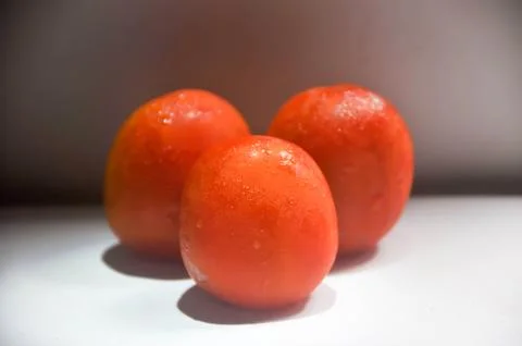 Three tomatoes Stock Photos