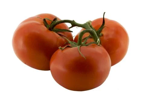 Three tomatoes on the vine b Stock Photos