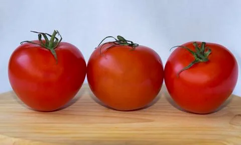 Three tomatoes white background Fotos Stock