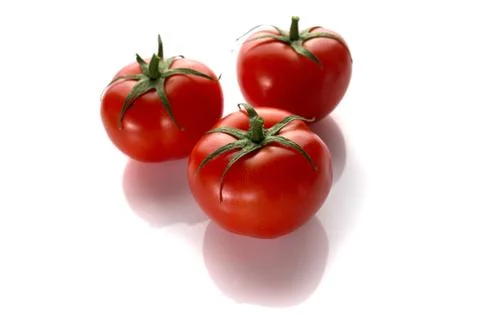 Three tomatoes on a white background Stock Photos