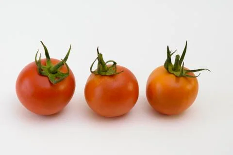Three tomatoes on white Foto stock