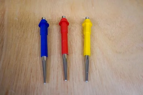 Three tool punches on a wood background Stock Photos