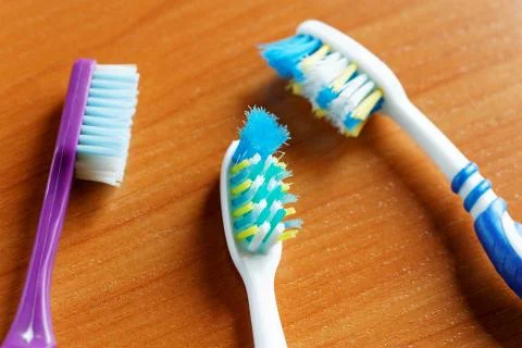 Three toothbrushes closeup on the table Stock Photos