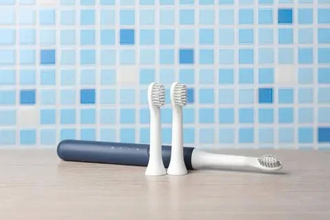 Three toothbrushes with toothpaste on a bathroom counter Fotos de archivo