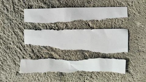 Three Torn White Paper Strips on Rough Concrete Texture Background Stock Photos
