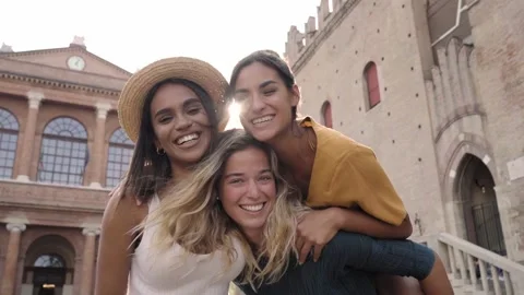 Three tourist friends having fun together. Group of happy people looking at Stock Footage 165935689