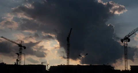 Three Tower Cranes Clouds and Sun Timelapse Stock Footage 140918631