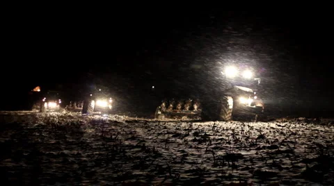 Three tractors plowing at night Stock Footage 987462