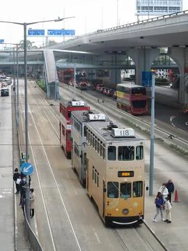 Three trams waiting for passengers to board in Sheung Wan, Hong Kong. Stock Photos