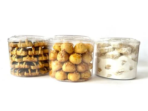 Three transparent plastic jars with assorted traditional cookies Stock Photos