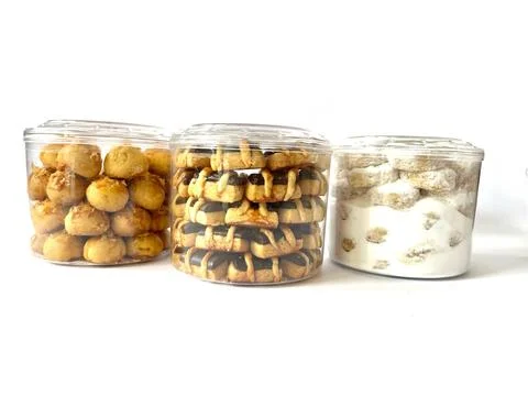 Three transparent plastic jars with assorted traditional cookies Foto stock