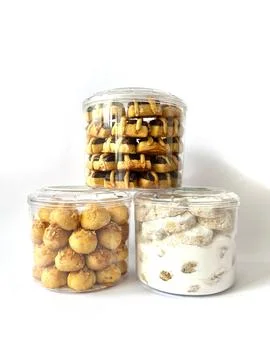 Three transparent plastic jars with assorted traditional cookies Stock Photos