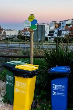 Three trash cans are lined up next to each other. Empremasa, empresa municipal Stock Photos