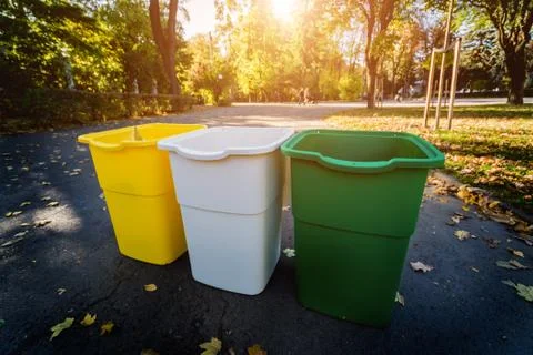 Three trash containers in different color, for sorted waste. Outdoors Stock Photos