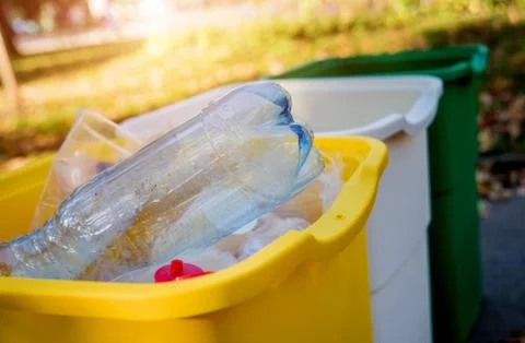Three trash containers in different color, for sorted waste. Stock Photos