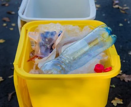 Three trash containers in different color, for sorted waste. Stock Photos
