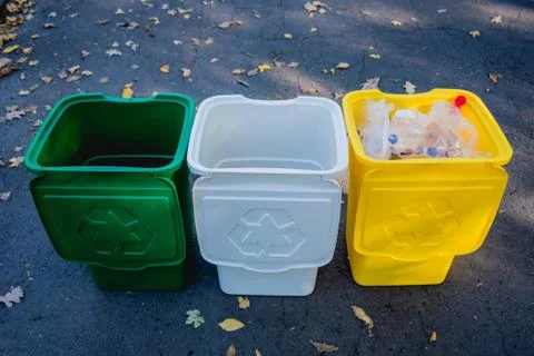 Three trash containers in different color, for sorted waste. Stock Photos