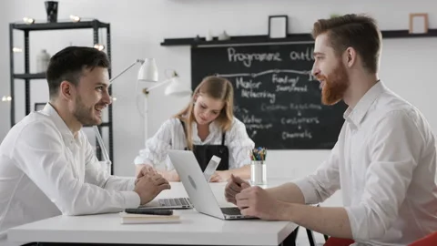 Three trendy 20s persons startup development of finance brainstorm solution. Han Video stock 199475519