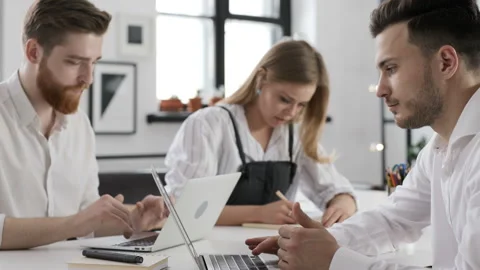 Three trendy partners start up brainstorm of success solution or report on pc sc Stock Footage 199475525