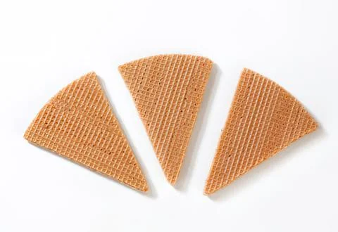Three triangular crackers on plain background Stock Photos